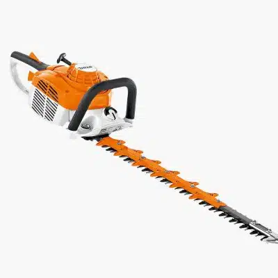 An orange and white STIHL petrol hedge trimmer with a long toothed blade is shown on a white studio background.