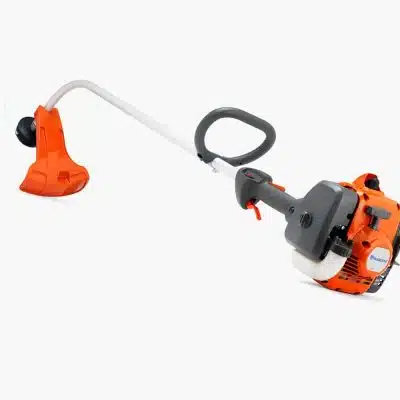 An orange and grey petrol grass trimmer with a curved shaft and loop handle is photographed on a white studio background.