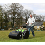 man pushing an Allett turf-care machine across a sports field