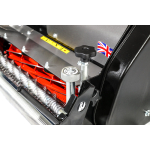 A tight close-up shows the red cutting reel, height-adjustment knob and a UK flag decal on a cylinder mower.