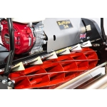 A close-up detail shot of a Buffalo 34 cylinder mower's red reel blades and Honda GX petrol engine.