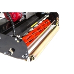 A close-up studio shot of a cylinder lawnmower's orange-bladed cutting reel and chrome rear roller.