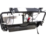 A close-up detail shot of a small petrol engine mounted above a black roller on a cylinder mower chassis.