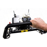A hand reaches to adjust the engine unit of a black cylinder mower, shown on a white studio background.