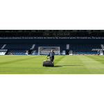 A groundsman pushes a mower across a football stadium pitch, with a psalm verse overlaid across the image.