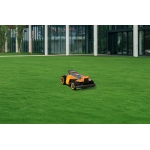 Navimow i110N robot lawn mower is on a green lawn.