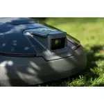 Close-up of a robotic lawn mower on grass.