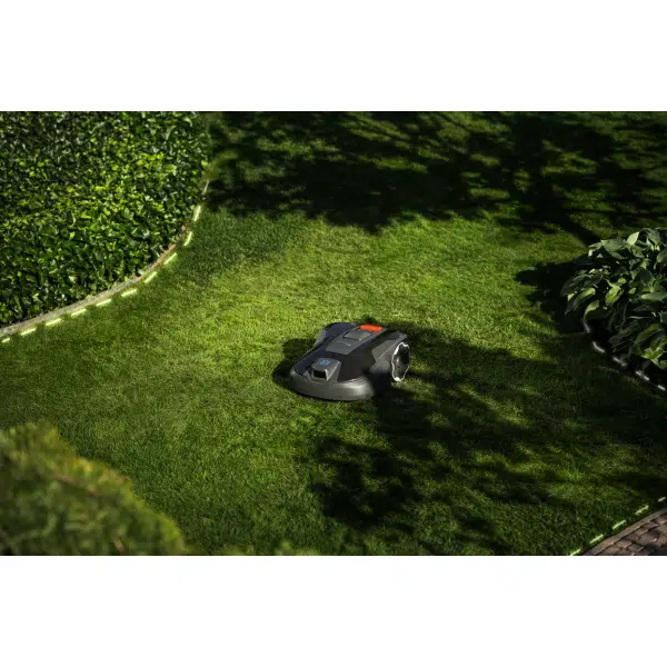 Robotic lawn mower operating in a well-maintained garden.