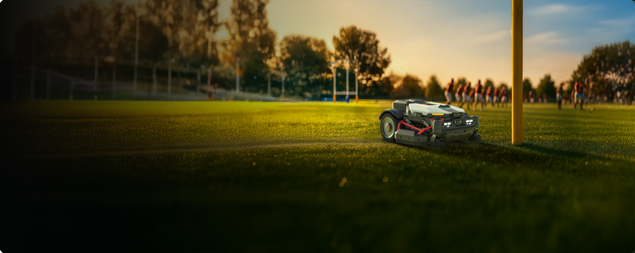 Kress robotic mower maintaining a sports pitch at dusk